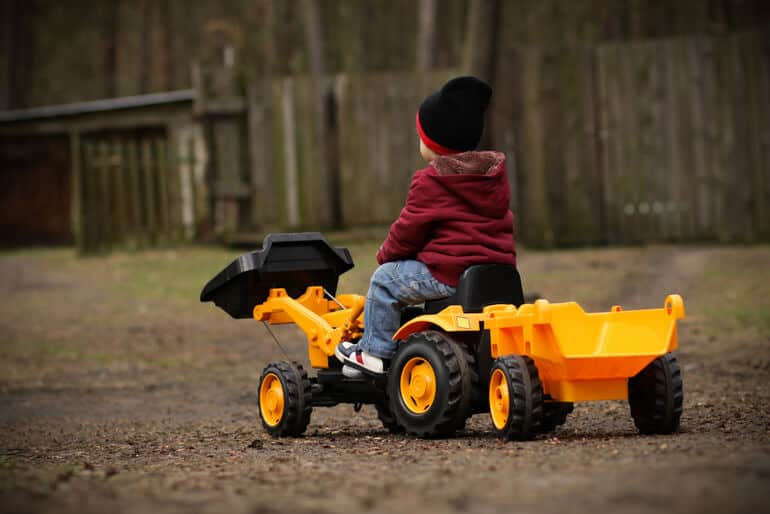 Boy on a toy tractor