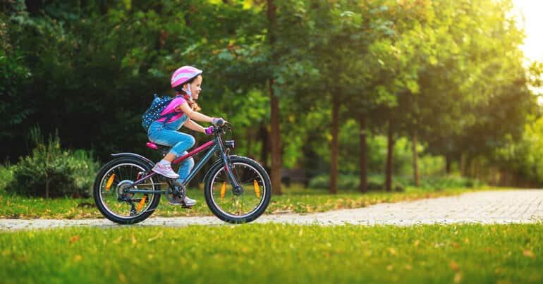 girl is headed to school by bike